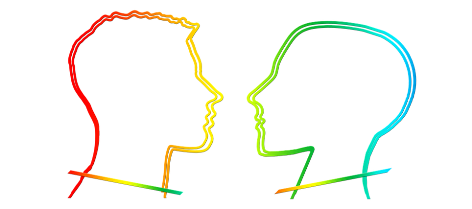Outline of two human heads facing each other