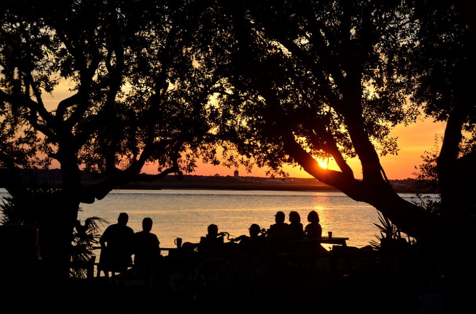 Silhouettes of people watching the sunset