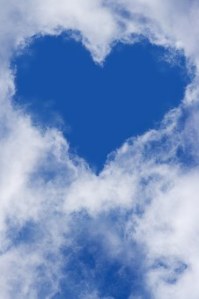 Cumulus Clouds that open to the sky forming the shape of blue heart