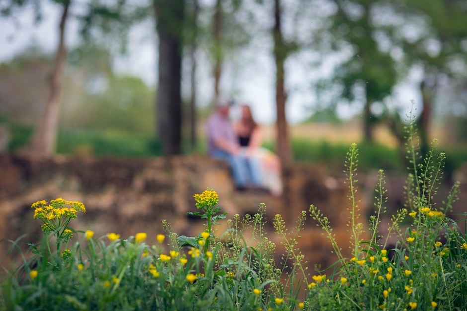 A couple sitting outside holding hands