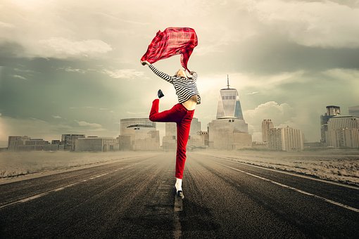 girl wearing red pants jumping for joy